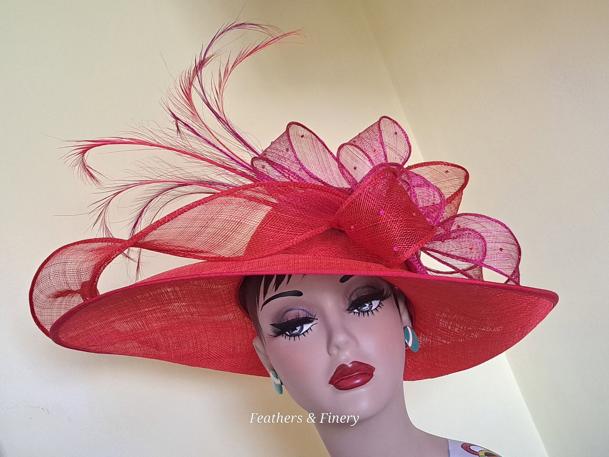 Red fascinator with feathers and netting