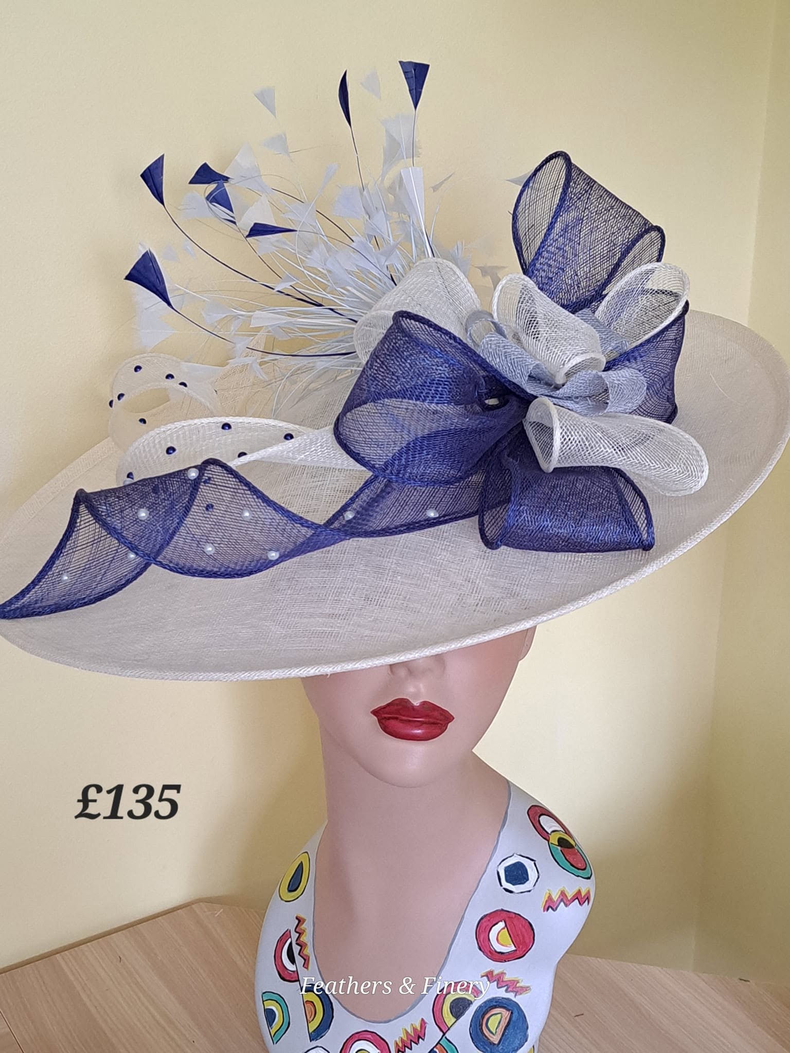 Navy and white fascinator with mesh bows and feathers