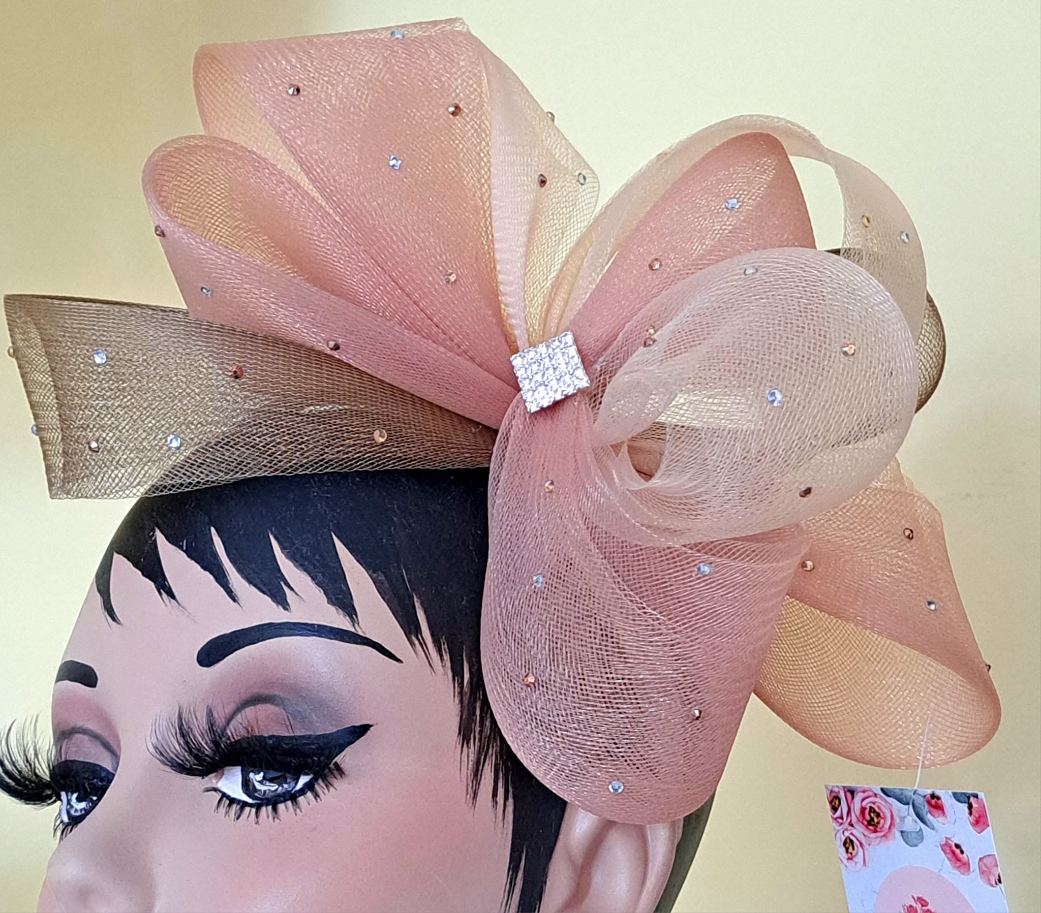 Pink fascinator with rhinestone embellishments and bow