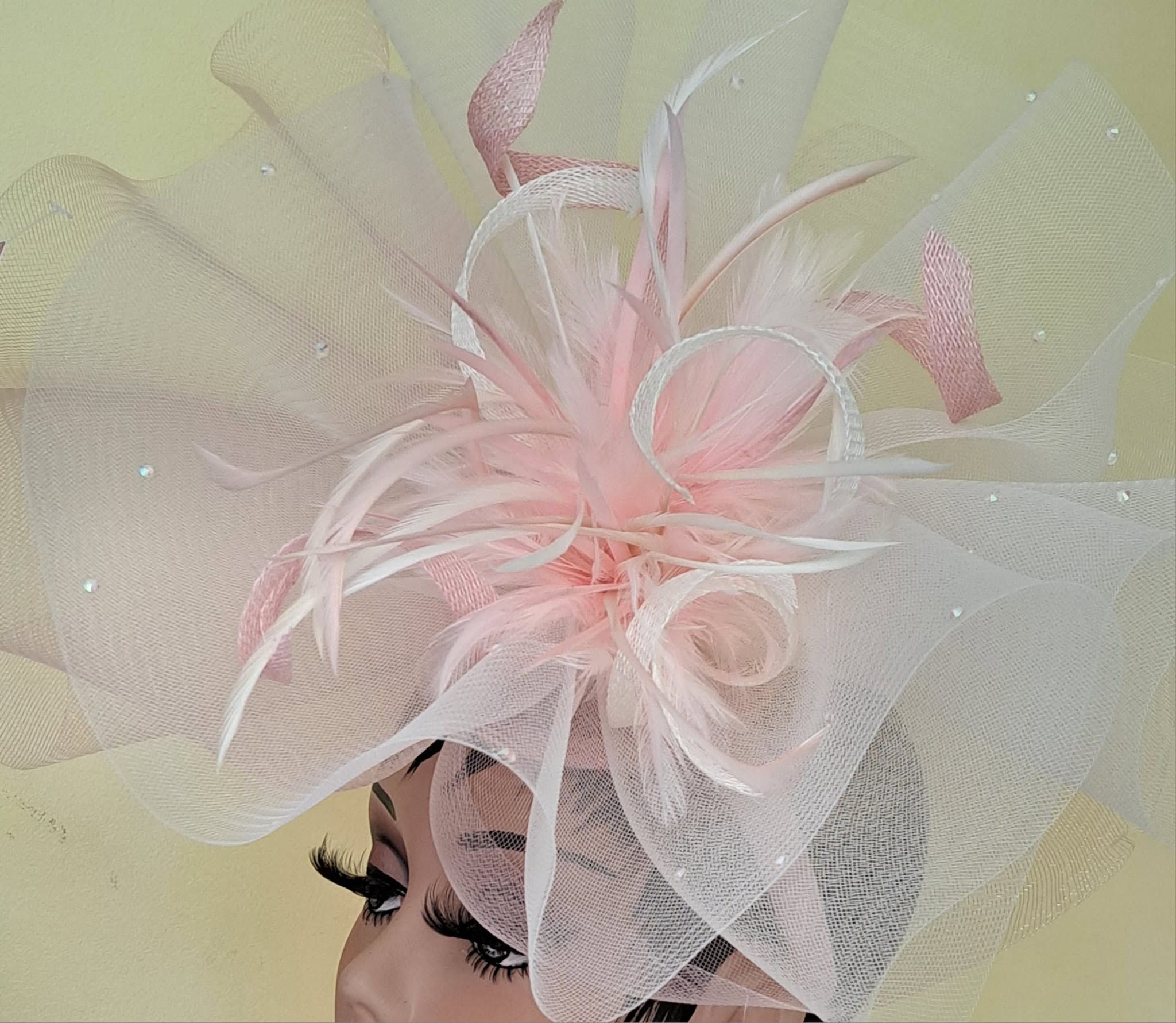 Pink and ivory fascinator with feathers and netting