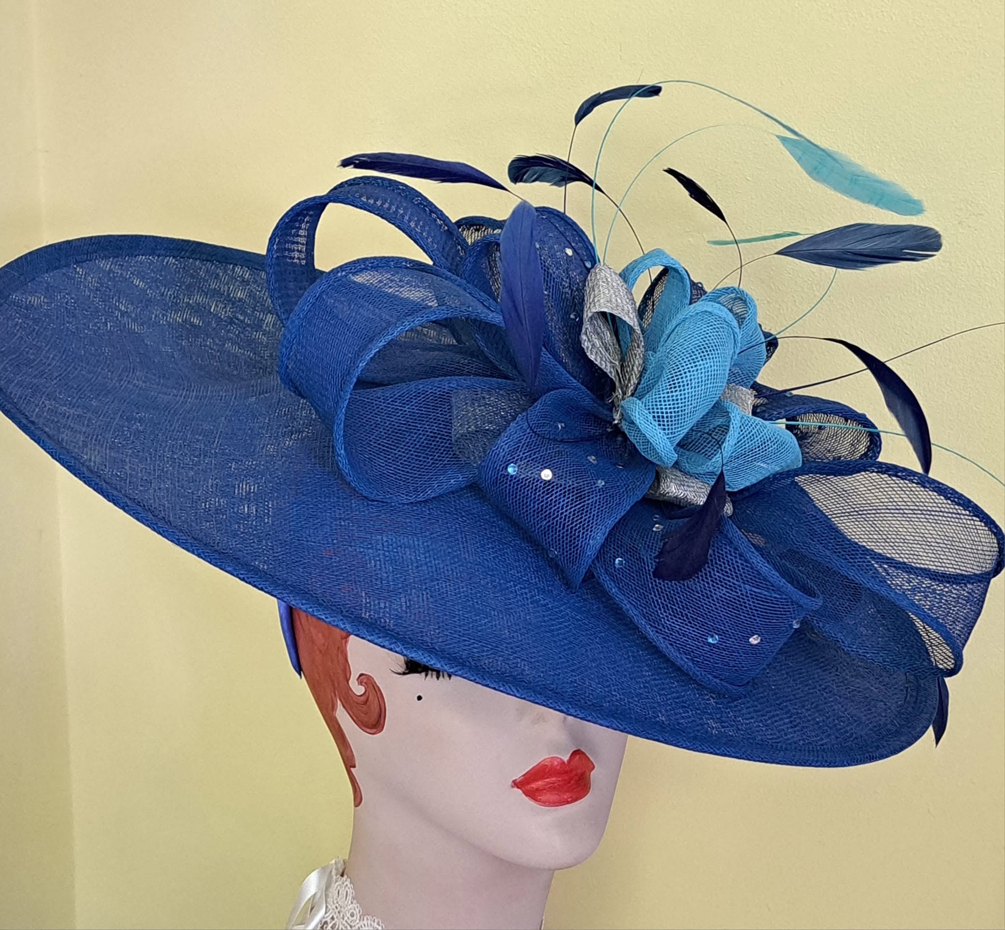 Blue fascinator with mesh flowers and feathers