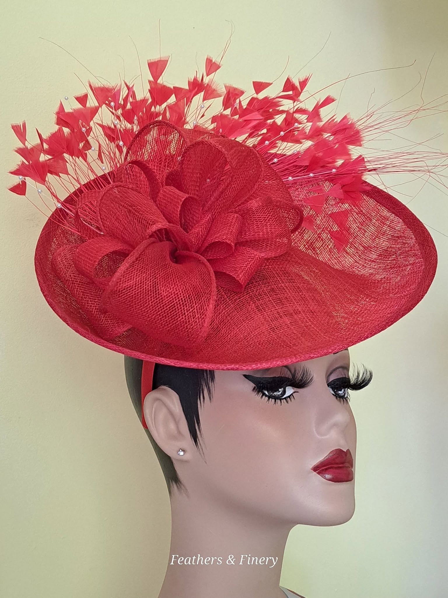 Bold red fascinator with dramatic feather embellishment